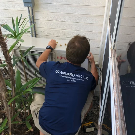 img of standard air technician outside a home
